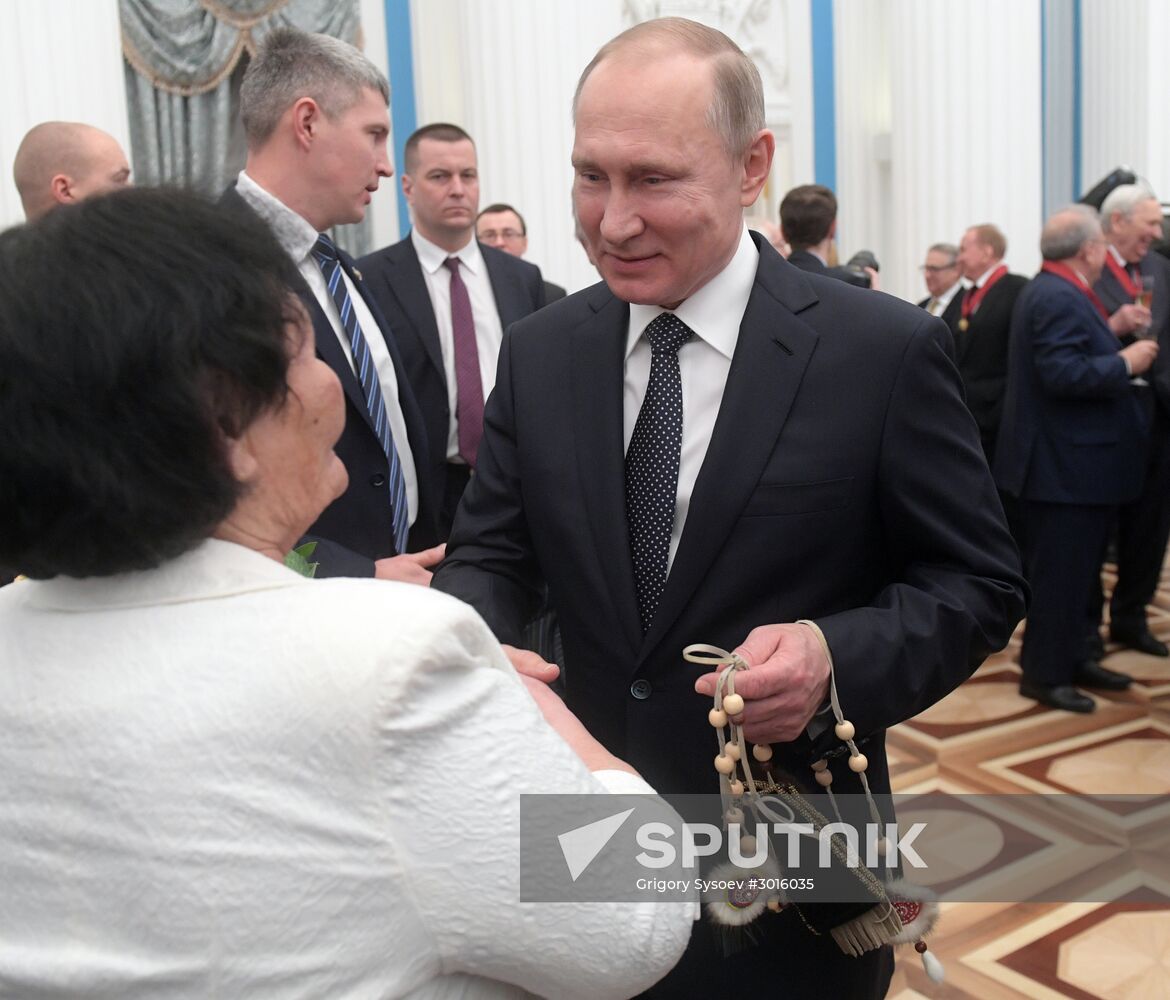 Russian President Vladimir Putin presents state decorations
