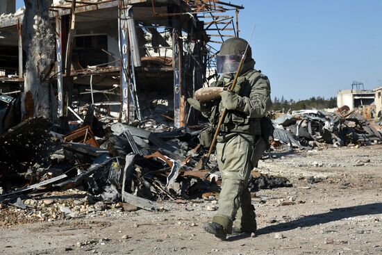 Russian Army Mine Action Center sappers inspect ruined buildings in Aleppo