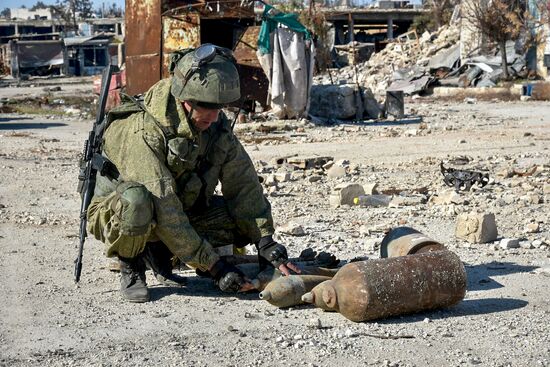 Russian Army Mine Action Center sappers inspect ruined buildings in Aleppo