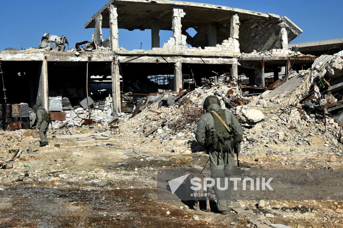 Russian Army Mine Action Center sappers inspect ruined buildings in Aleppo
