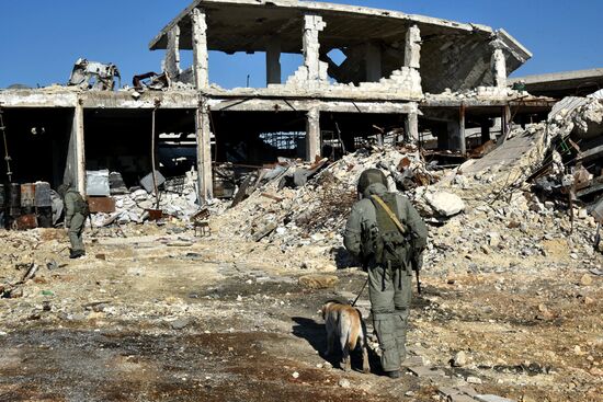 Russian Army Mine Action Center sappers inspect ruined buildings in Aleppo
