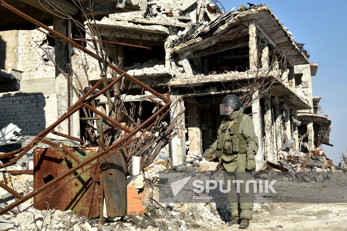 Russian Armed Force Mine Action Centre sappers inspect ruined buildings in Aleppo