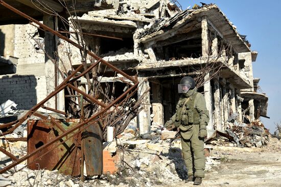 Russian Armed Force Mine Action Centre sappers inspect ruined buildings in Aleppo