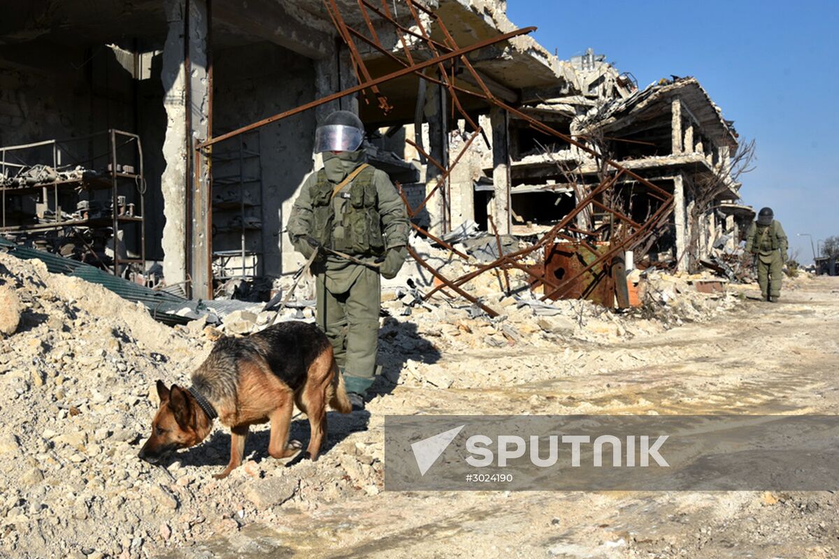Russian Armed Force Mine Action Centre sappers inspect ruined buildings in Aleppo