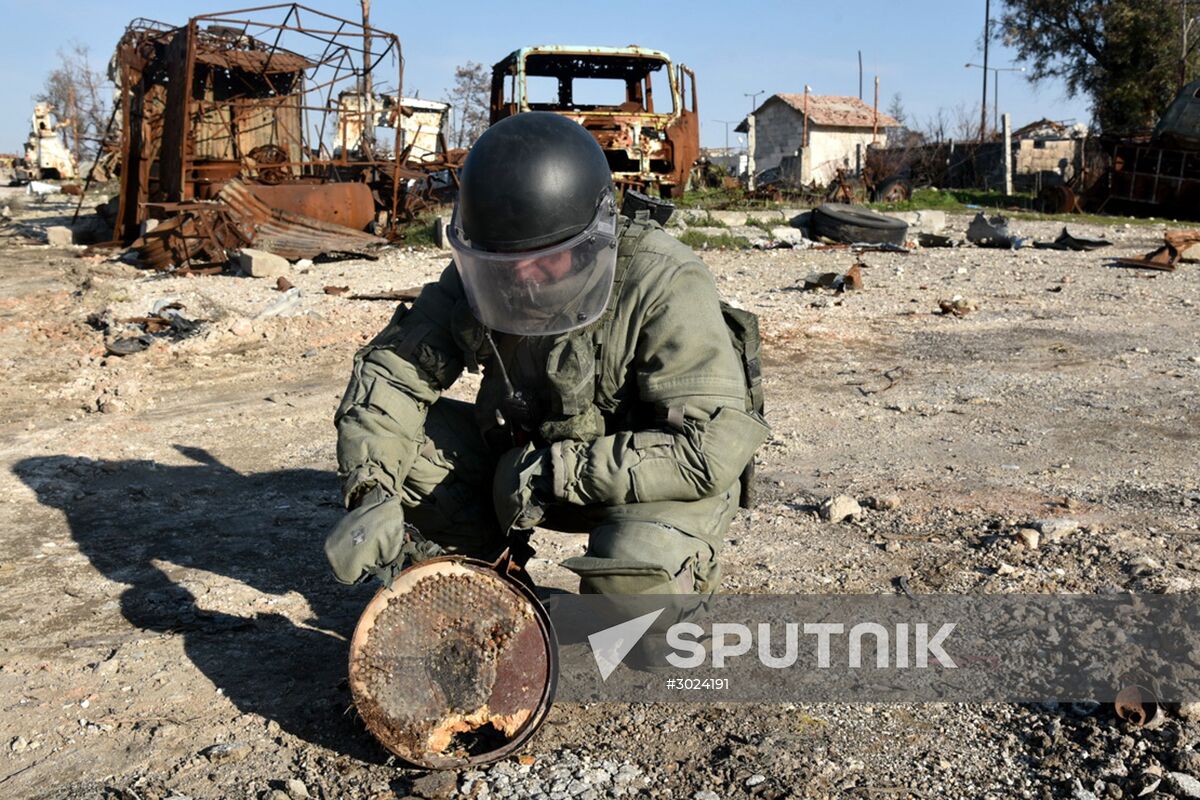 Russian Armed Force Mine Action Centre sappers inspect ruined buildings in Aleppo
