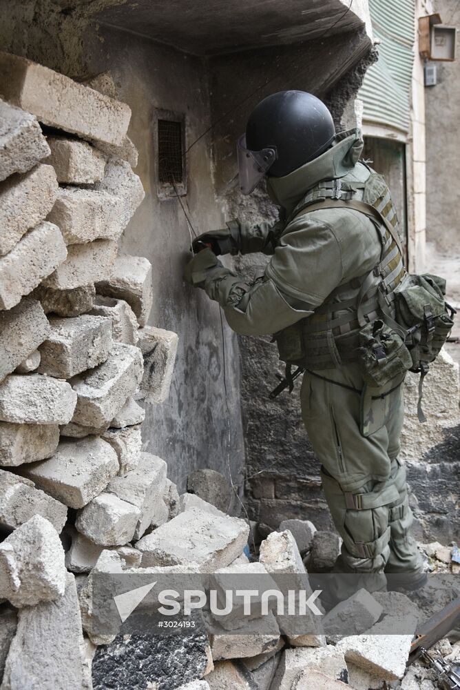 Russian Army Mine Action Center sappers inspect ruined buildings in Aleppo