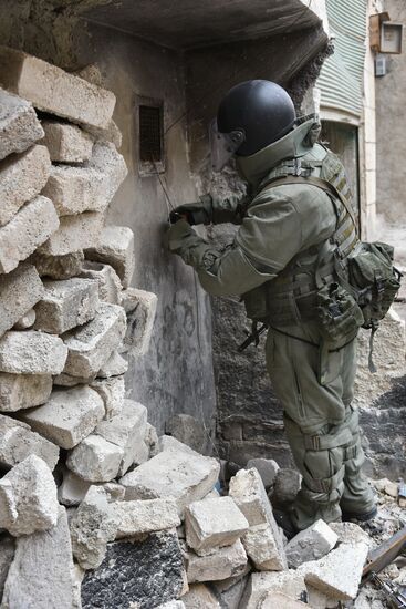 Russian Army Mine Action Center sappers inspect ruined buildings in Aleppo
