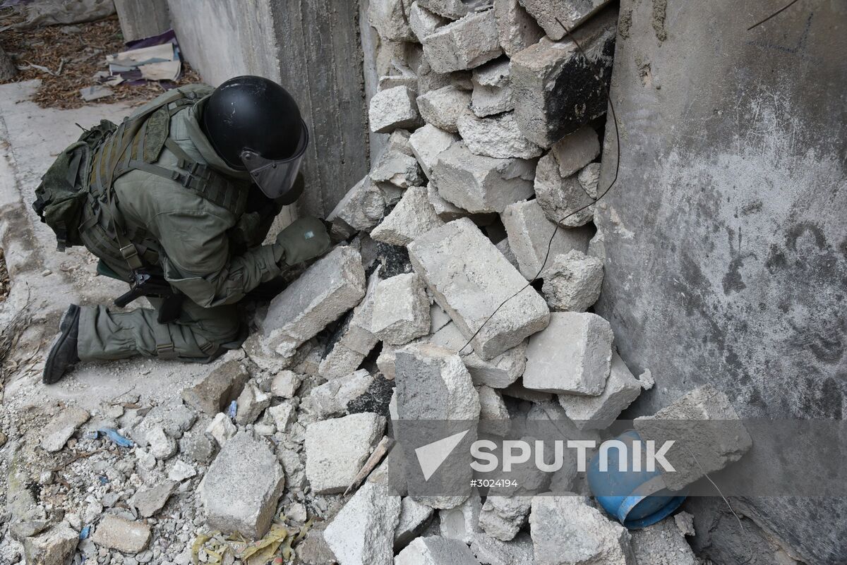 The Russian Armed Force Mine Action Centre sappers inspect ruined buildings in Aleppo