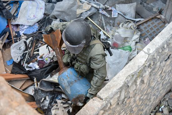 Russian Armed Force Mine Action Centre sappers inspect ruined buildings in Aleppo