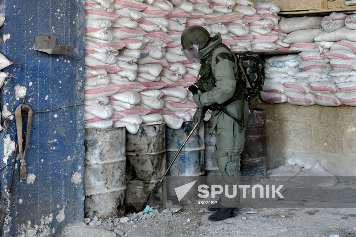 Russian Armed Force Mine Action Centre sappers inspect ruined buildings in Aleppo