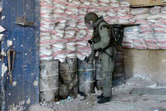 Russian Armed Force Mine Action Centre sappers inspect ruined buildings in Aleppo