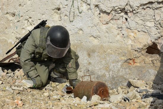 Russian Armed Force Mine Action Centre sappers inspect ruined buildings in Aleppo