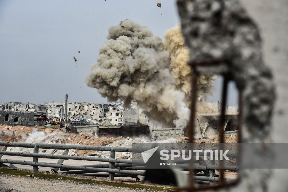 Russian Armed Force Mine Action Centre sappers inspect ruined buildings in Aleppo
