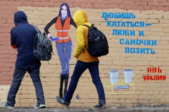 Mara Bagdasaryan portrayed as street cleaner on graffiti in Saint Petersburg