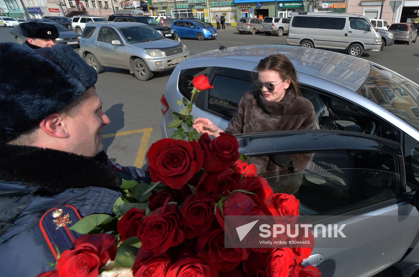 Traffic police officers congratulate women in the run-up to March 8