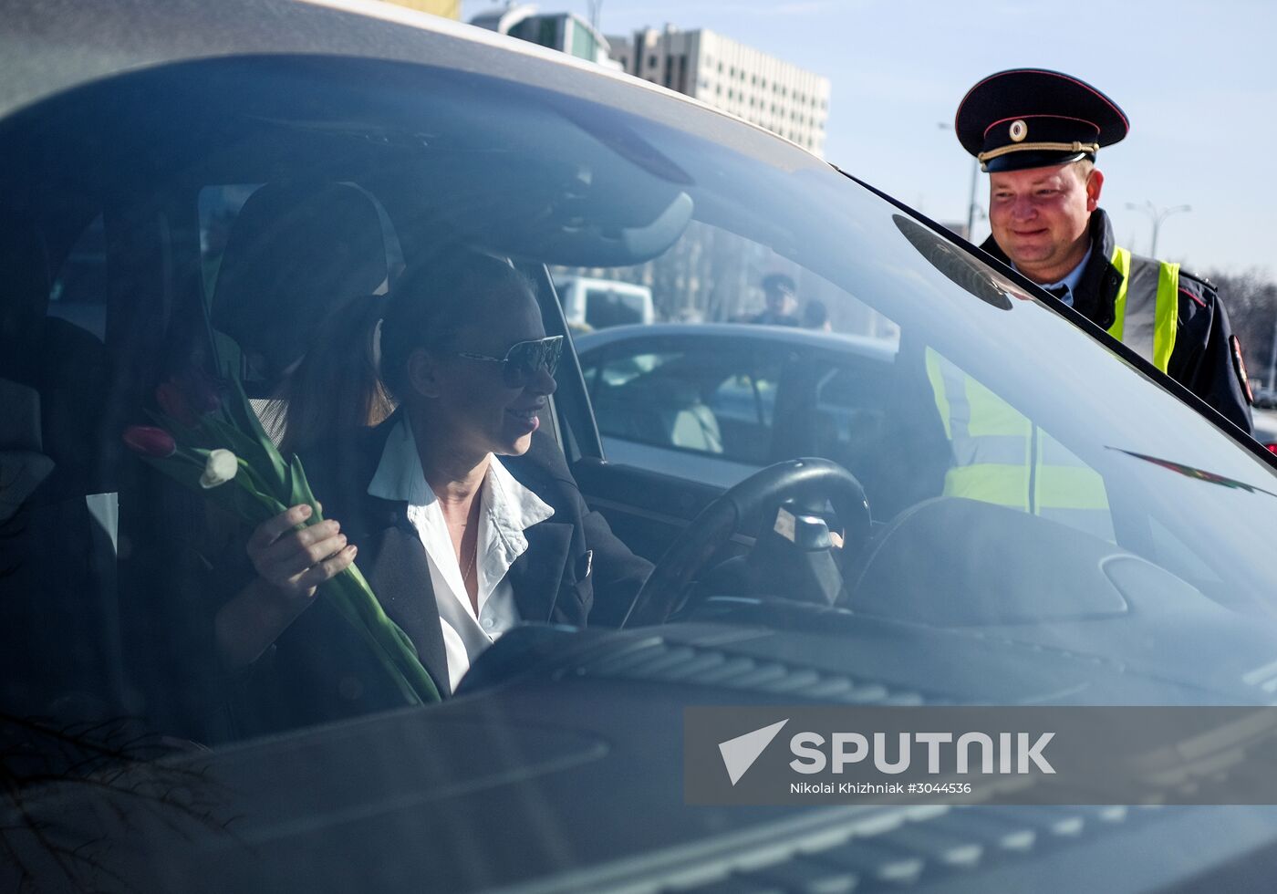 Traffic police officers congratulate women in the run-up to March 8