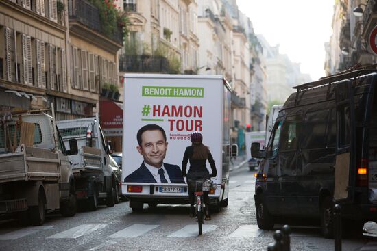 Campaign vans featuring pictures of presidential candidate Benoit Hamon in France