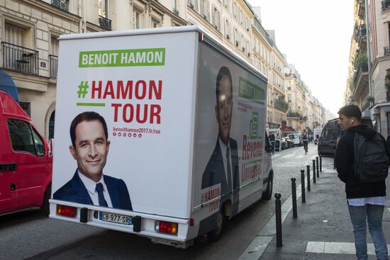 Campaign vans featuring pictures of presidential candidate Benoit Hamon in France