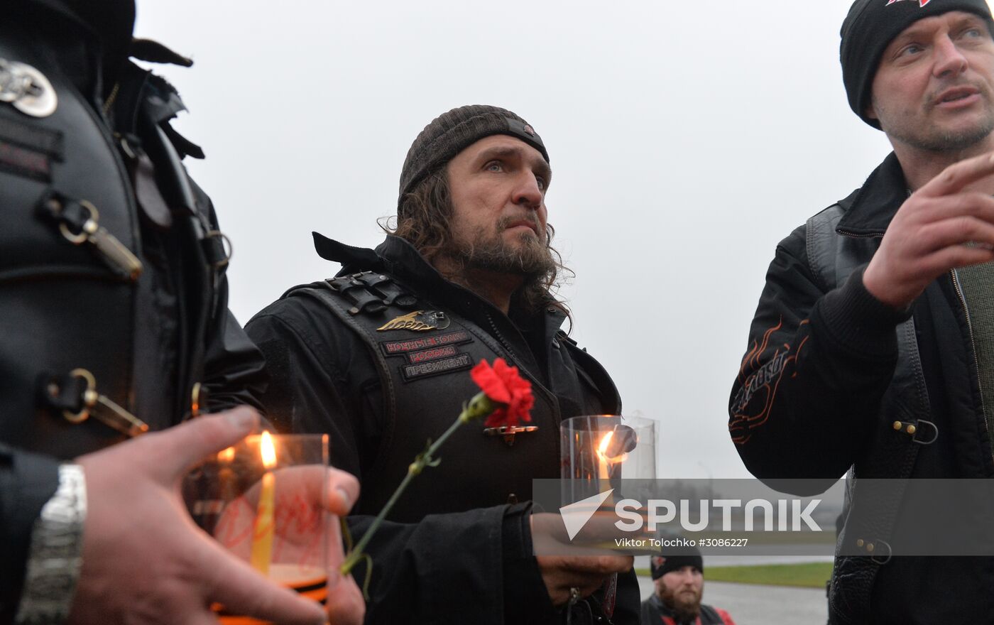 Night Wolves motorcycle club members lay flowers at the Mound of Glory in Minsk