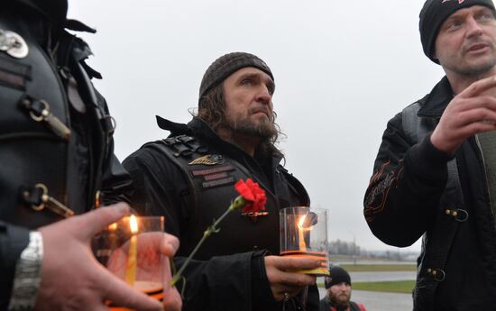 Night Wolves motorcycle club members lay flowers at the Mound of Glory in Minsk