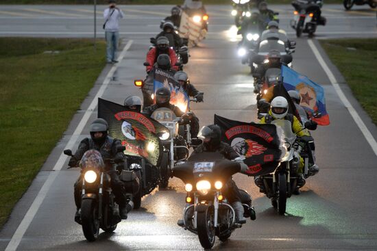 Night Wolves motorcycle club members lay flowers at the Mound of Glory in Minsk