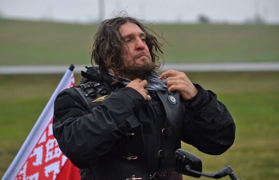 Night Wolves motorcycle club members lay flowers at the Mound of Glory in Minsk