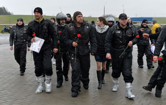 Night Wolves motorcycle club members lay flowers at the Mound of Glory in Minsk