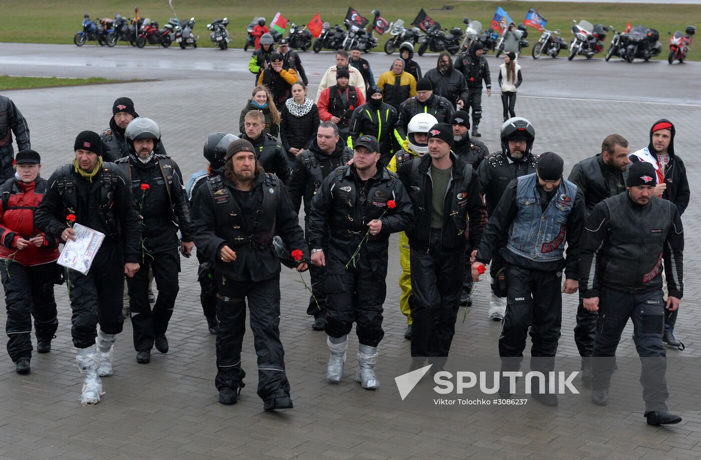 Night Wolves motorcycle club members lay flowers at the Mound of Glory in Minsk