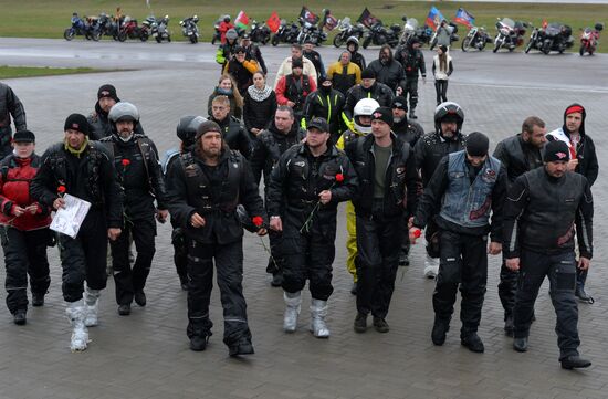 Night Wolves motorcycle club members lay flowers at the Mound of Glory in Minsk