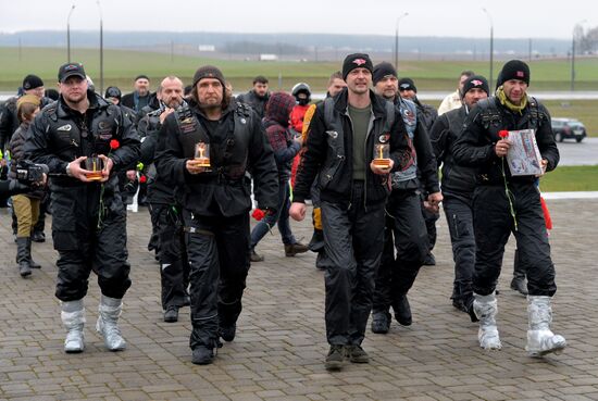 Night Wolves motorcycle club members lay flowers at the Mound of Glory in Minsk