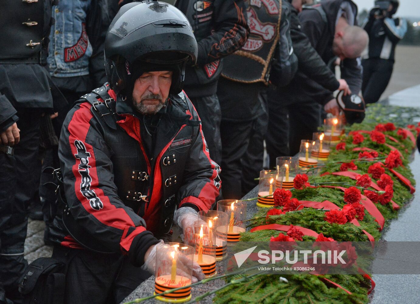 Night Wolves motorcycle club members lay flowers at the Mound of Glory in Minsk