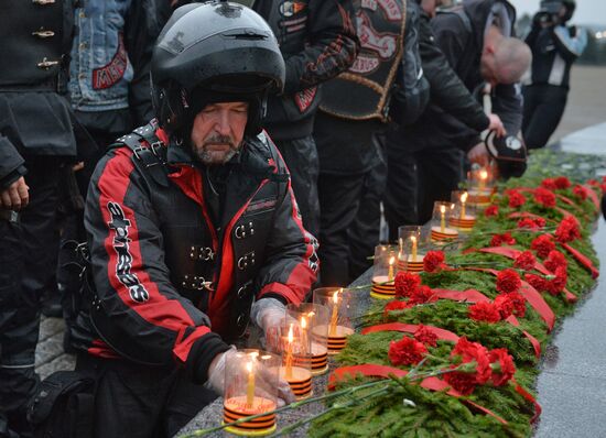 Night Wolves motorcycle club members lay flowers at the Mound of Glory in Minsk