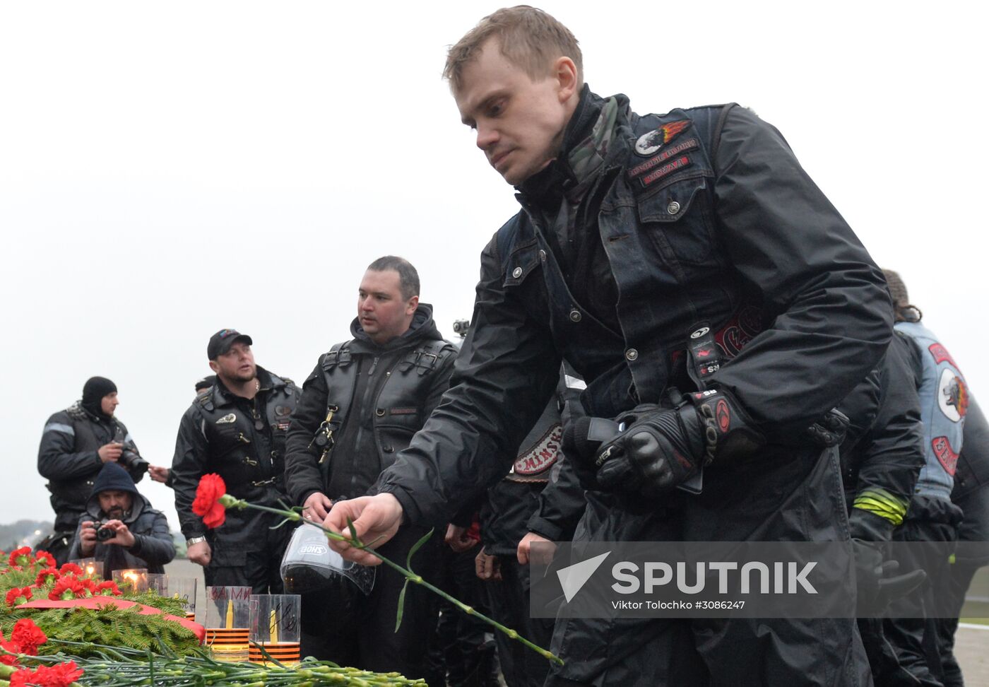 Night Wolves motorcycle club members lay flowers at the Mound of Glory in Minsk