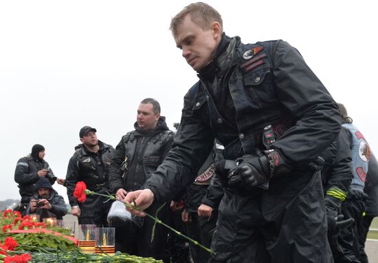 Night Wolves motorcycle club members lay flowers at the Mound of Glory in Minsk