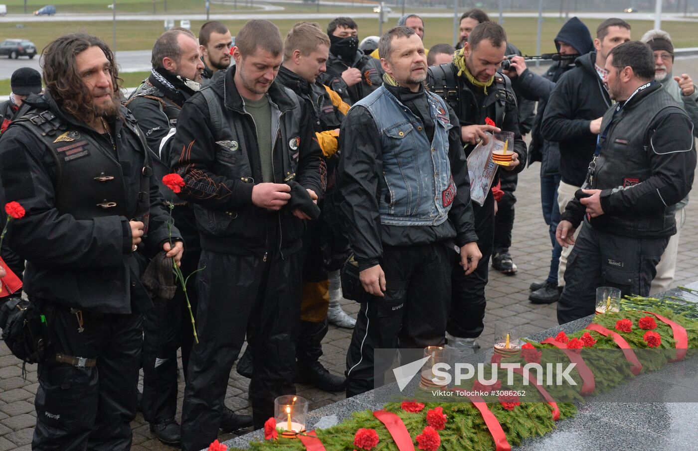 Night Wolves motorcycle club members lay flowers at the Mound of Glory in Minsk