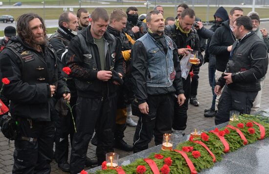 Night Wolves motorcycle club members lay flowers at the Mound of Glory in Minsk