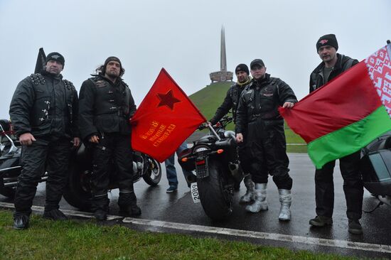 Night Wolves motorcycle club members lay flowers at the Mound of Glory in Minsk