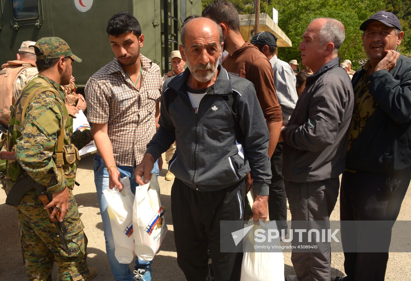 Servicemen of Russian center for reconciliation of the warring parties in Syria deliver humanitarian aid to Syrian village of Joubet Burghal