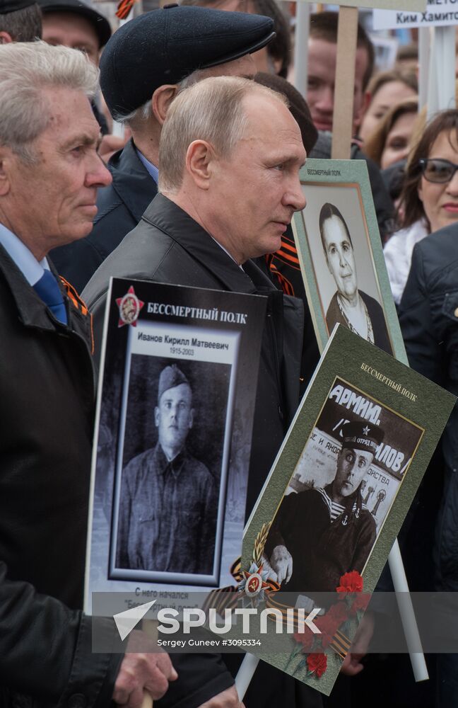 Russian President Vladimir Putin takes part in Immortal Regiment march