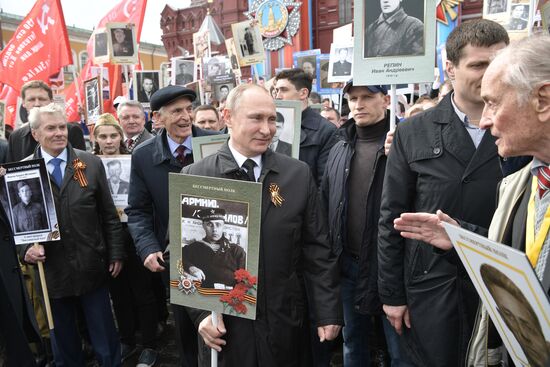 Russian President Vladimir Putin takes part in Immortal Regiment march