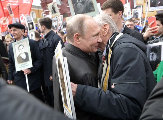 Russian President Vladimir Putin takes part in Immortal Regiment march
