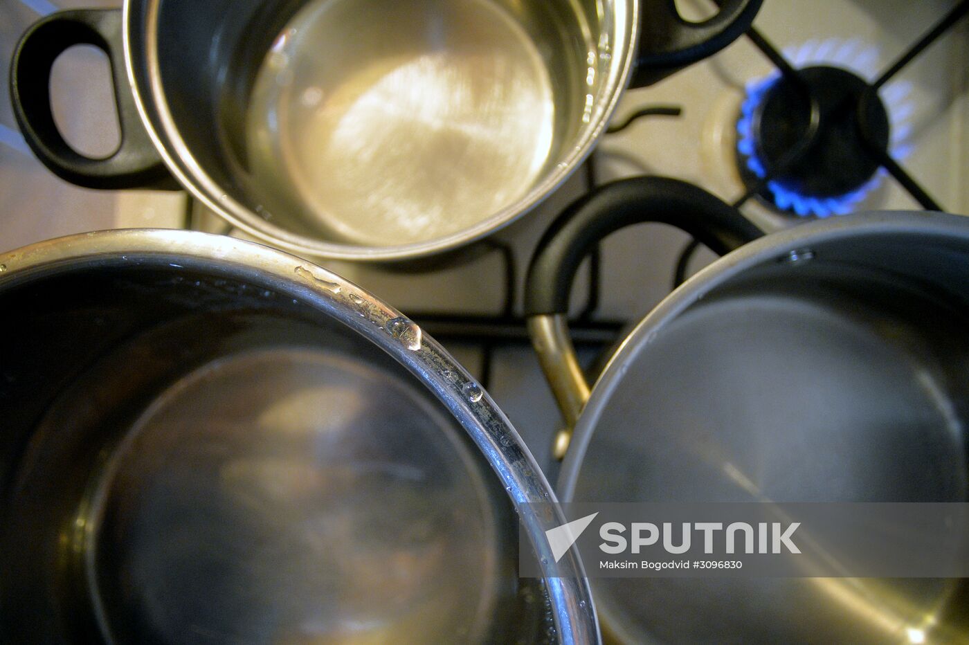 Pots with water on gas stove