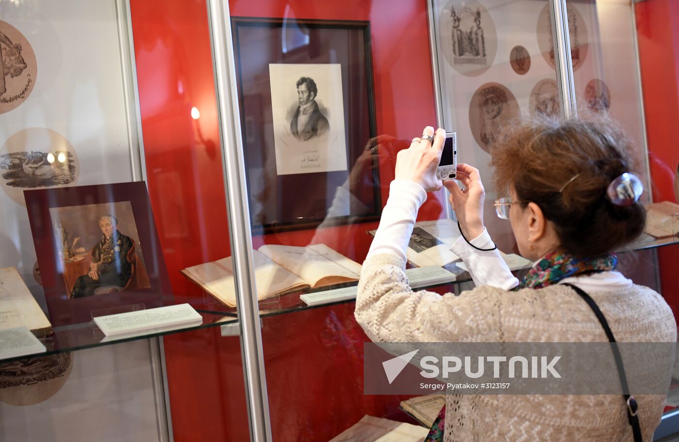 A visitor takes photo of exhibits at the opening of the exhibition, Alexander Pushkin's Editions and Publications in his Lifetime, at the Pushkin State Museum in Moscow. Location: Russia, Moscow. Author: Sergey Pyatakov/Sputnik. "Alexander Pushkin's Editions and Publications in his Lifetime" exhibition