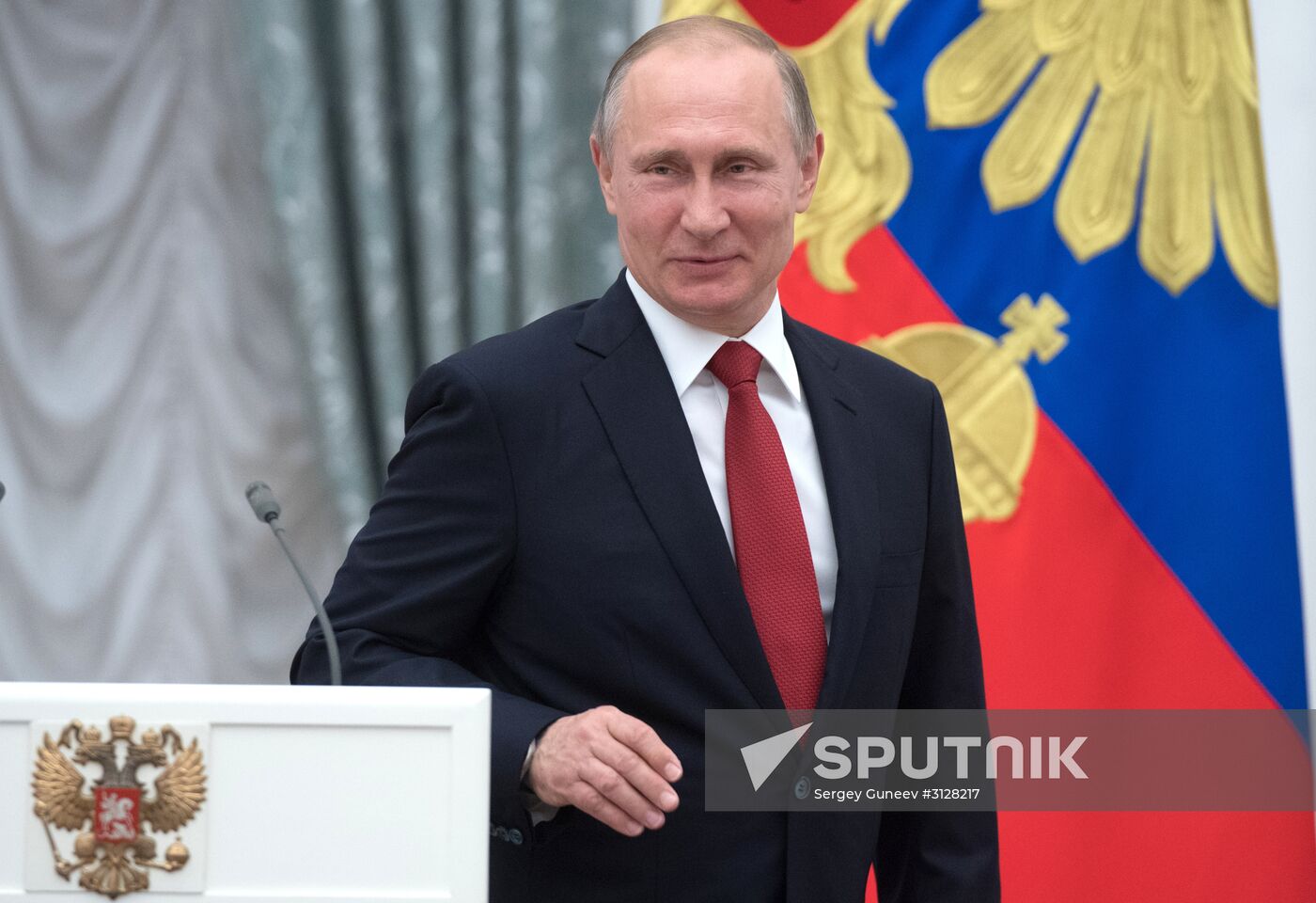 Russian President Vladimir Putin presents passports to young Russian citizens on Russia Day