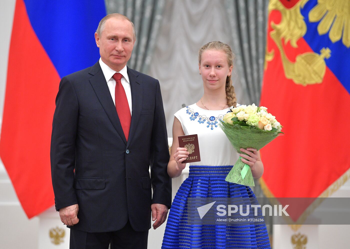 Russian President Vladimir Putin presents passports to young Russian citizens on Russia Day