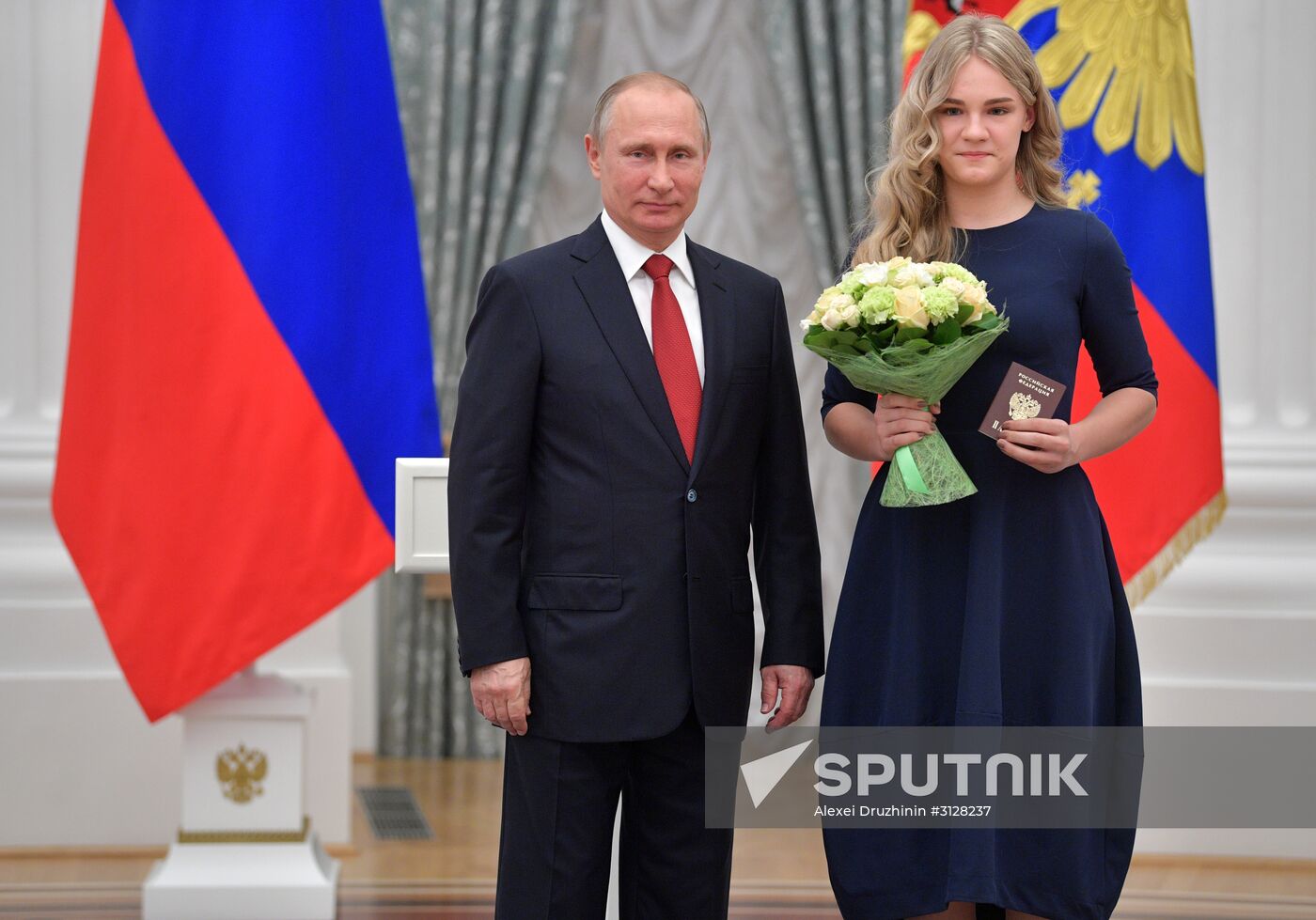 Russian President Vladimir Putin presents passports to young Russian citizens on Russia Day