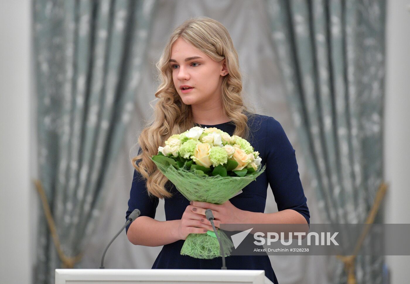 Russian President Vladimir Putin presents passports to young Russian citizens on Russia Day