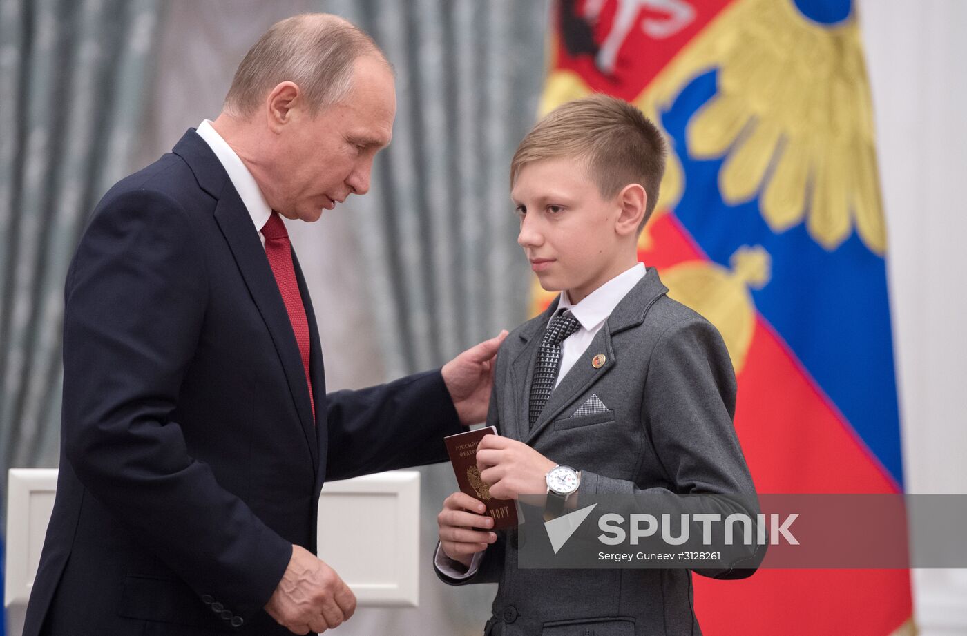 Russian President Vladimir Putin presents passports to young Russian citizens on Russia Day