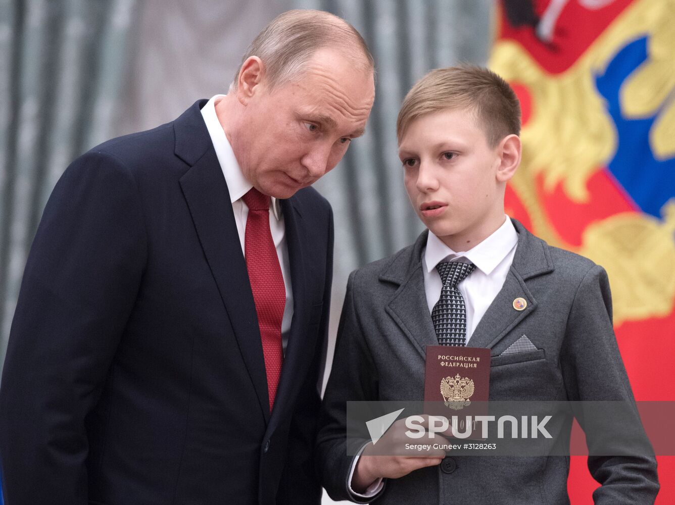 Russian President Vladimir Putin presents passports to young Russian citizens on Russia Day