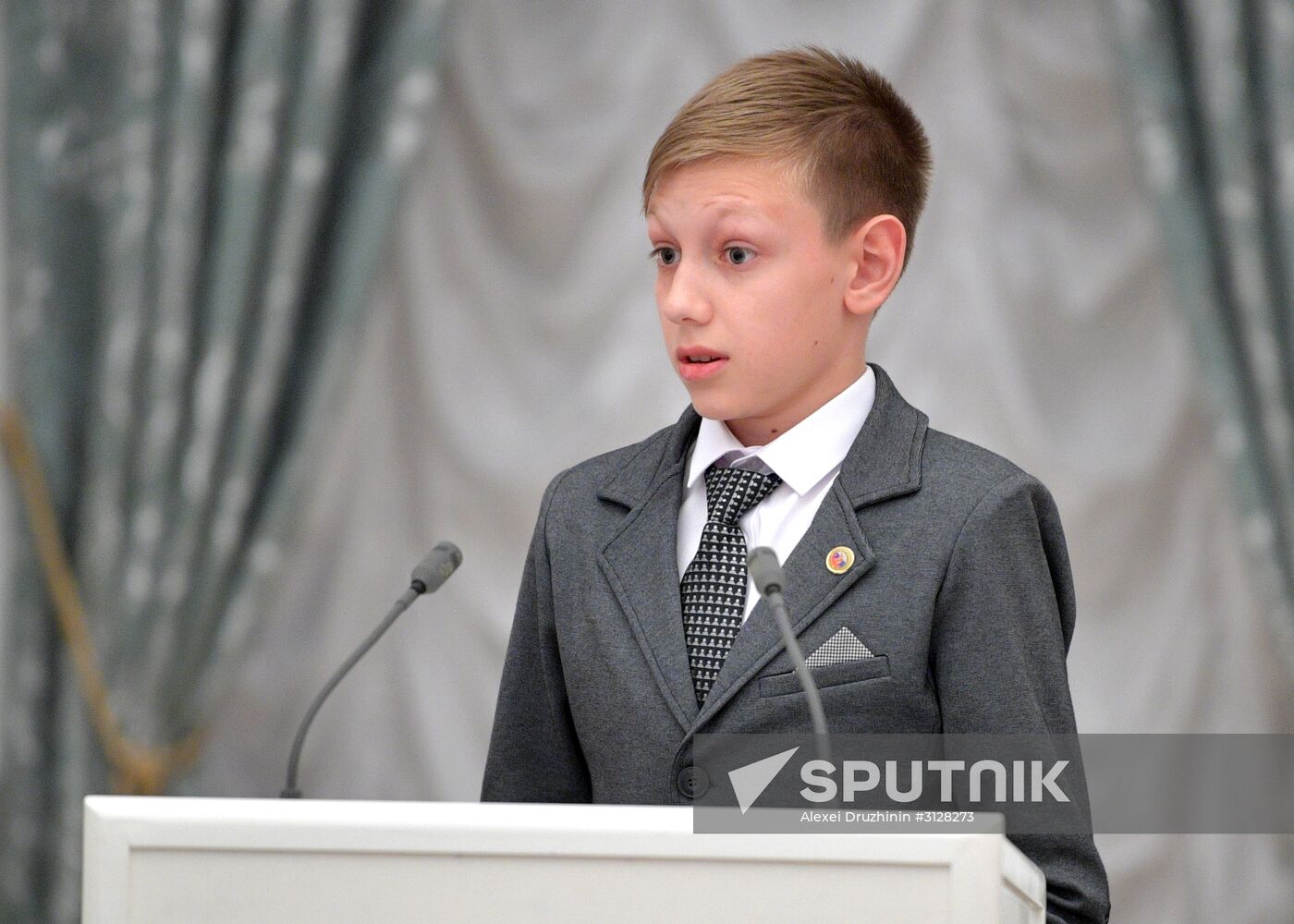 Russian President Vladimir Putin presents passports to young Russian citizens on Russia Day